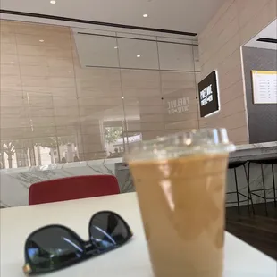 a glass of iced coffee on a table