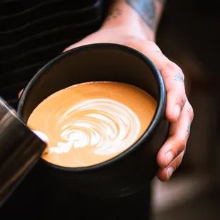 a person holding a cup of coffee
