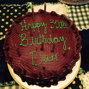 a chocolate birthday cake with green icing