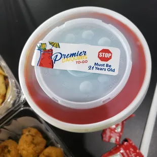 a container of donuts and a container of dipping sauce