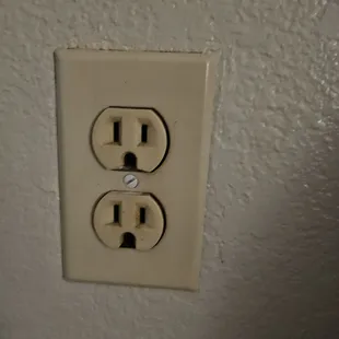 Outlet near the entrance door. Not safe of plugging your charger or whatever it is. DANGER