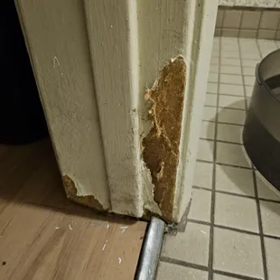 At the bottom of the bathroom door