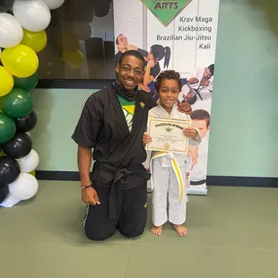 My son graduating belts with Mikey!