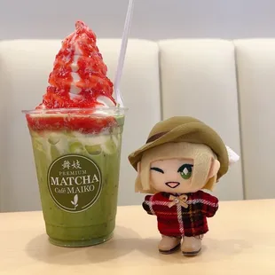 Vanilla matcha float with strawberry sauce