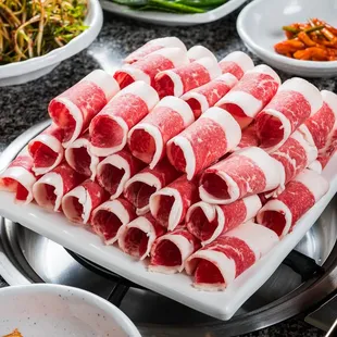 a large platter of raw meat