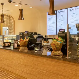 a coffee shop counter with a variety of items