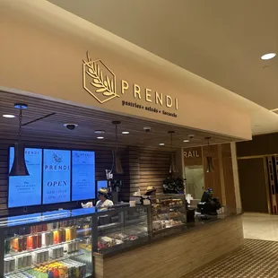 the inside of a restaurant with a large screen