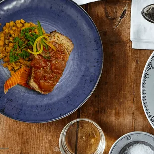 a plate of food on a wooden table