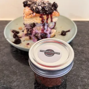 a blueberry cake and a jar of jam