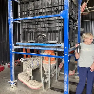 a woman standing in front of a machine