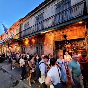 a crowd of people standing outside of a building