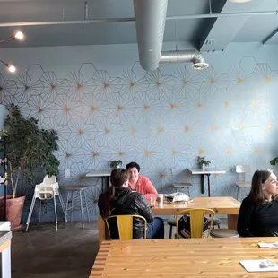 two people sitting at tables in a restaurant