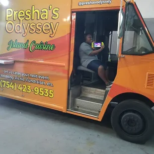 a man sitting in a food truck