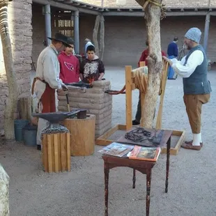 Blacksmith demonstration right next to the original cornerstone and pit house.