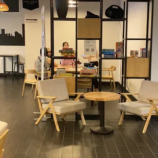 a woman sitting at a table in a coffee shop