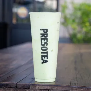 a green smoothie on a wooden table