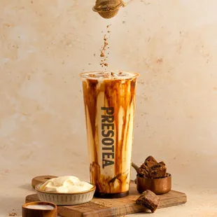 a person scooping ice cream into a cup