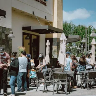 a crowd of people outside a restaurant