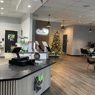 a coffee shop with a christmas tree in the background