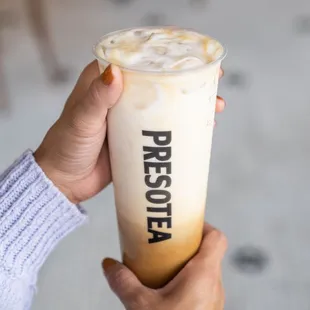 a person holding a cold beverage