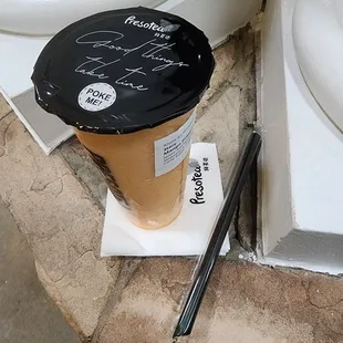 a cup of coffee and a pen