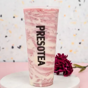a pink marbled smoothie with a flower on a white plate