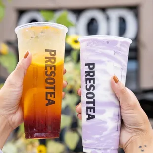 a person holding a drink and a plastic cup