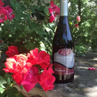 a bottle of wine and flowers