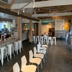 a bar with white chairs