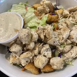 Chicken Caesar salad comes on mixed greens instead of traditional Romain. Tasty dressing &amp; chicken