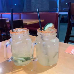 two masons with drinks in them