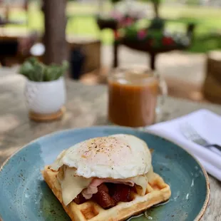 a waffle sandwich with an egg on top