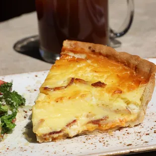 a slice of quiche and salad