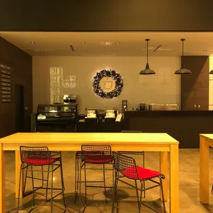 a counter and chairs in a coffee shop