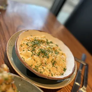 a bowl of pasta and a plate of salad