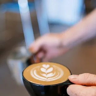 a person holding a cup of coffee