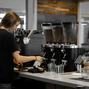 a woman making a cup of coffee