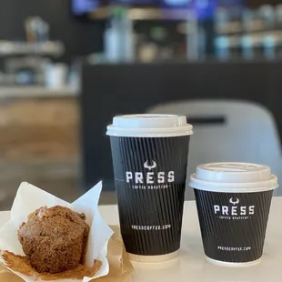 two coffee cups and a muffin