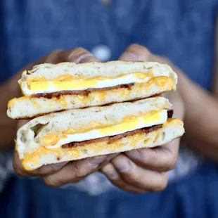 a person holding a sandwich