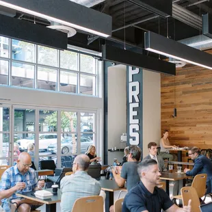 people sitting at tables in a coffee shop