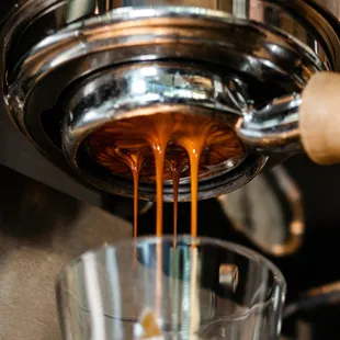 coffee being poured into a glass