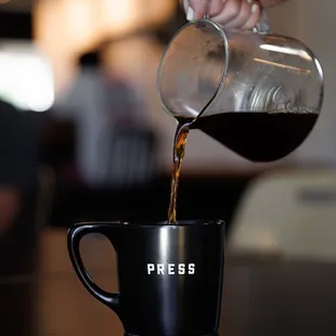 coffee being poured into a coffee cup