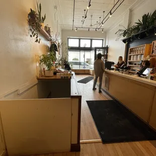a man standing at a counter in a coffee shop