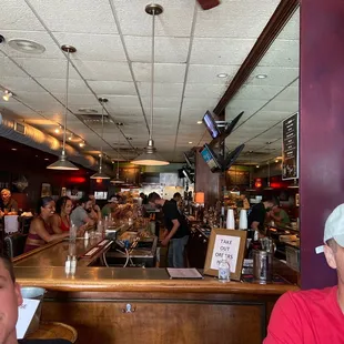 two men sitting at a bar