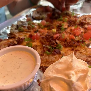 a person taking a slice of pizza