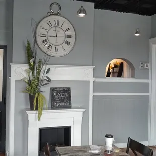 You can see my tea and brownie on the table, with a wall clock and a window into the serving area beyond.