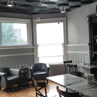 This is another seating area with tables and those leather chairs by the bay window.