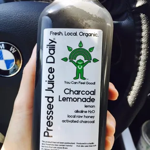 a hand holding a bottle of liquid