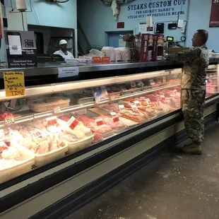 a soldier standing in front of a display case