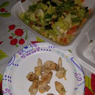 a plate of chicken and salad